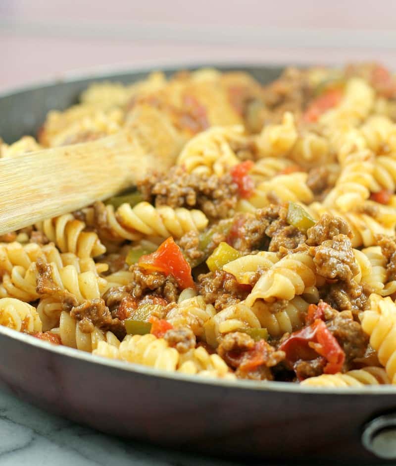 sloppy joe pasta in a skillet with a wooden spoon