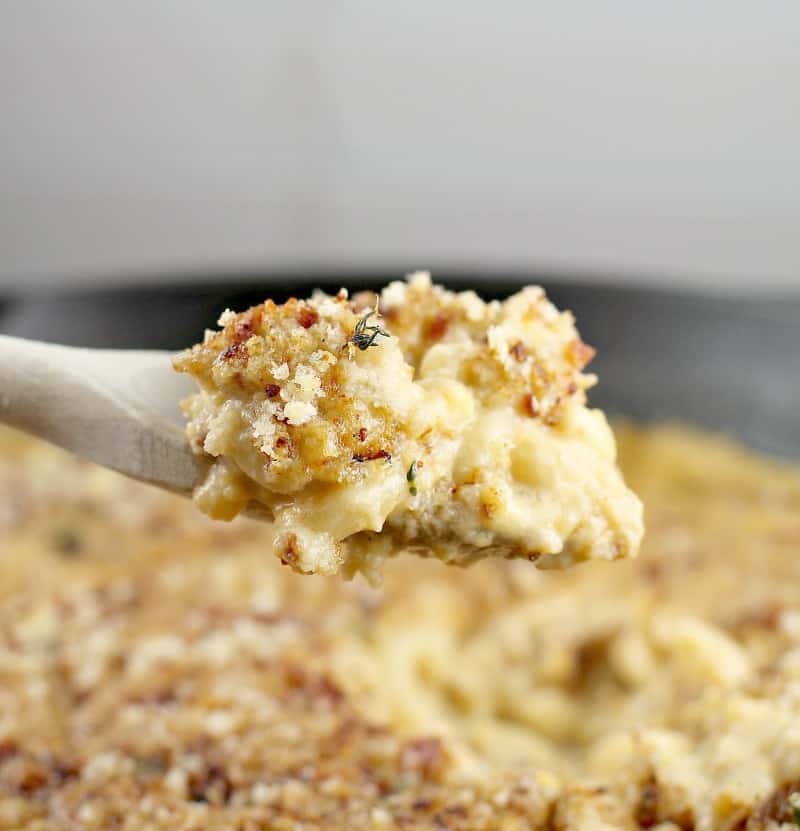 side view of a wooden spoon scooping up a bit of the beer mac and cheese