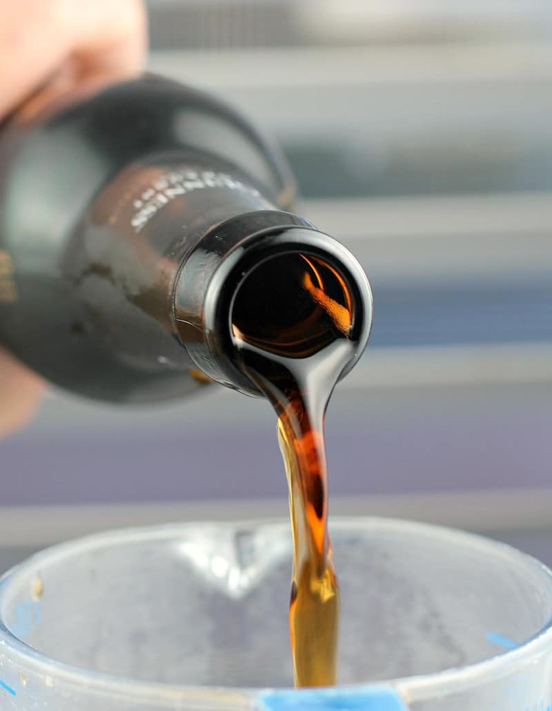 dark stout beer being poured into a measuring cup