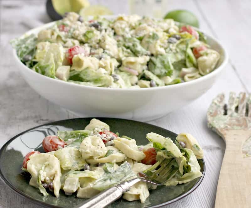 plated salad on a green dish with fork