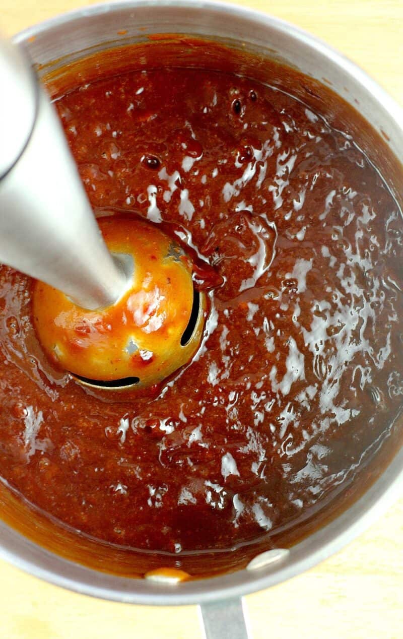 immersion blender in a pan blending sauce