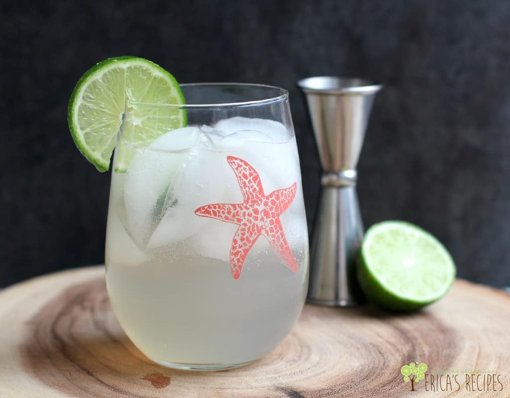 glass with ice and drink and lime wedge; pink starfish decal is on the glass