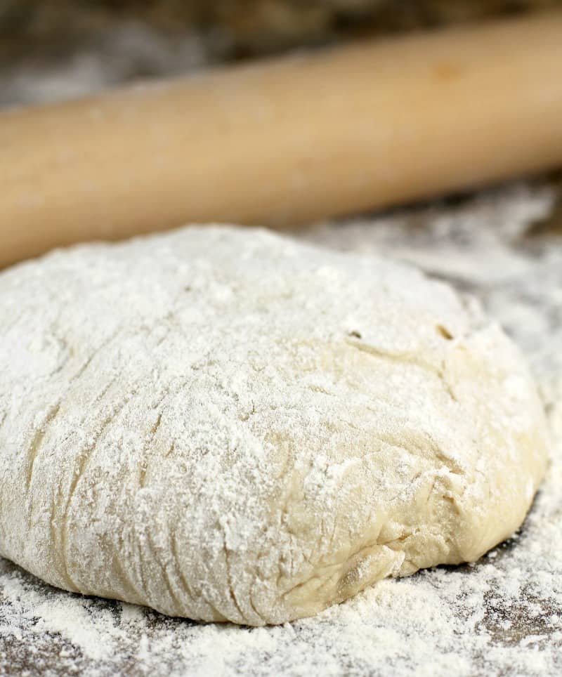 pizza dough on a flour surface