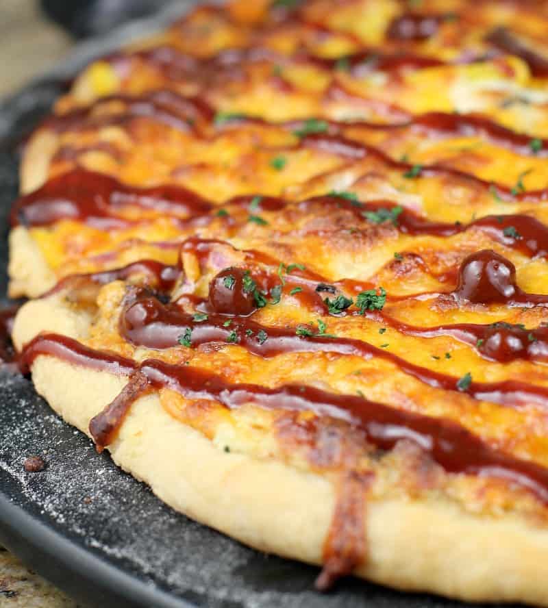 cooked pizza with bbq sauce drizzled over