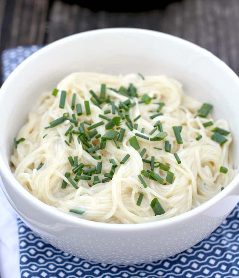close view of sour cream and chive pasta in white bowl