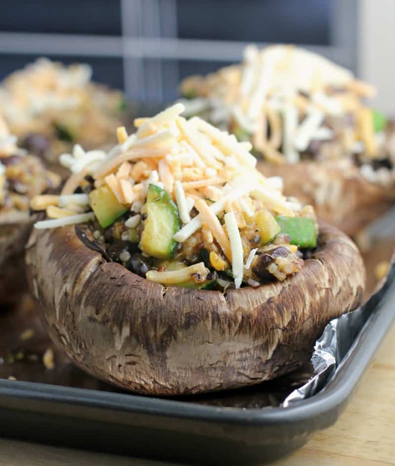 uncooked portobello with the quinoa stuffed topped with shredded cheese