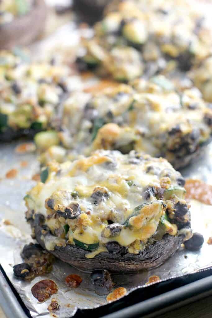 cooked, cheesy stuffed mushrooms on the bake sheet