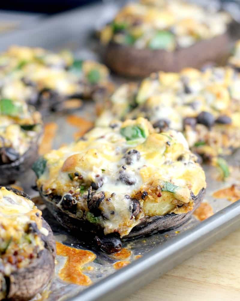 cooked mushrooms on a bake sheet topped with cheese