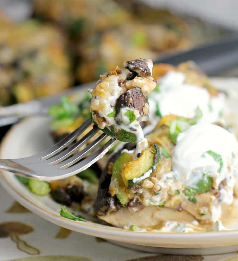 fork scooping a bite of stuffed mushroom