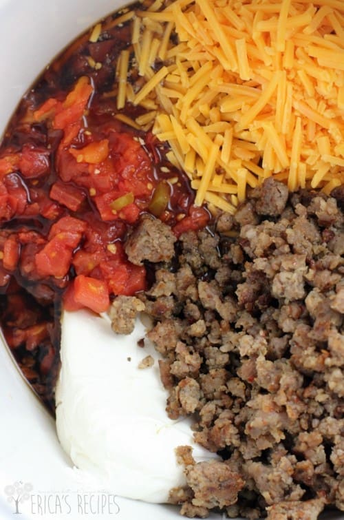 top down view of the ingredients for the Guiness extra stout queso with shredded cheese, Rotel tomatoes and green chiles, cream cheese, and sausage