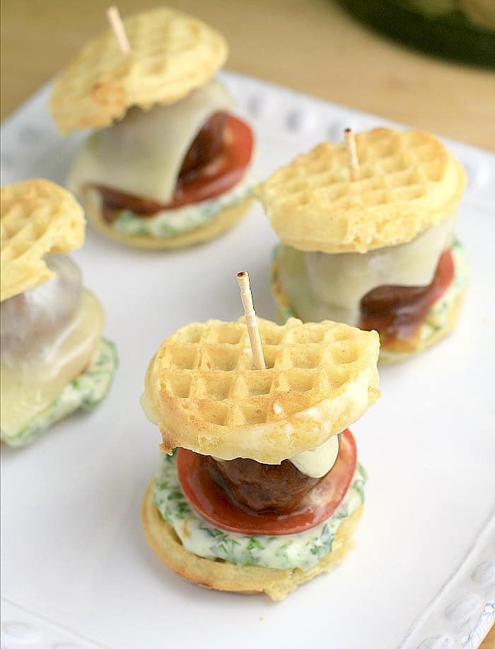 assembled sliders on a white dish with a toothpick in each