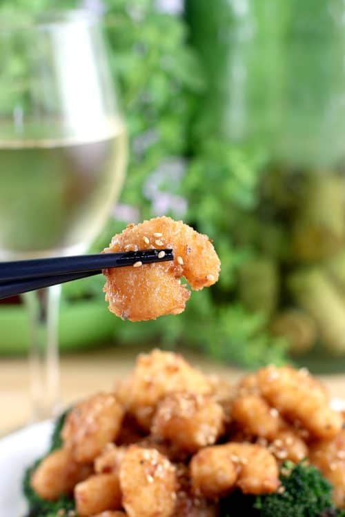 chopsticks holding up a single shrimp