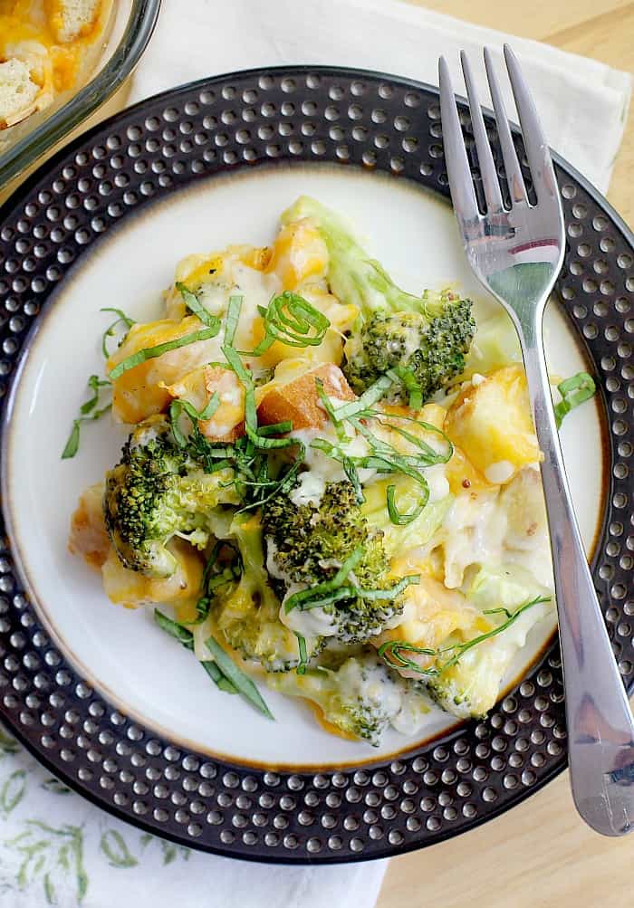 top down view of broccoli and cheese casserole on a brown-rimmed dish with fork