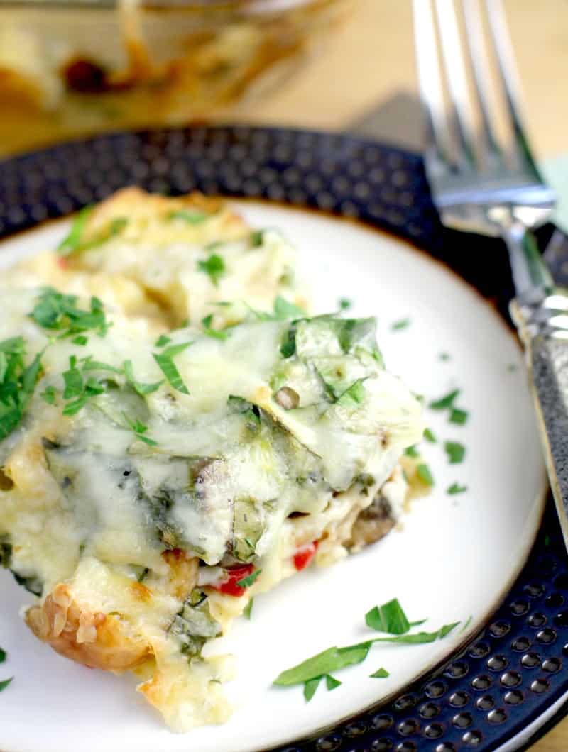 casserole on a plate with fork, topped with parsley