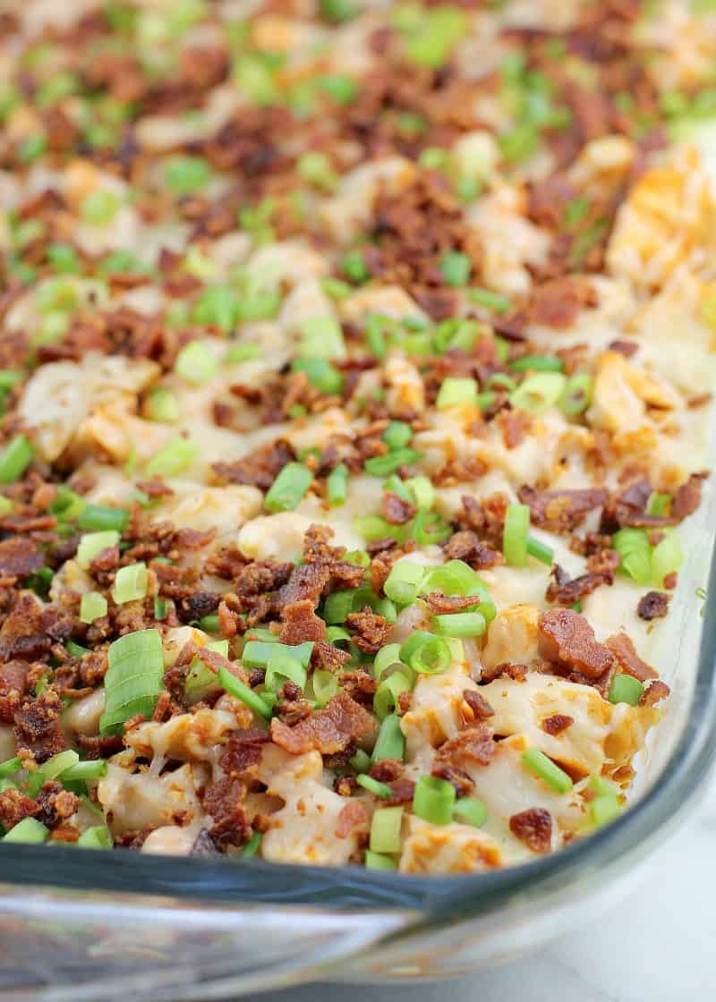 top view showing the bacon and cheese on the rest of the dip in a clear glass bake dish