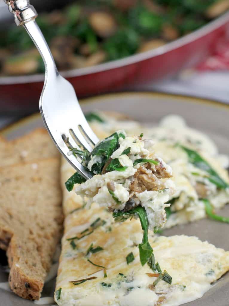 finished omelet with a fork holding up a biteful