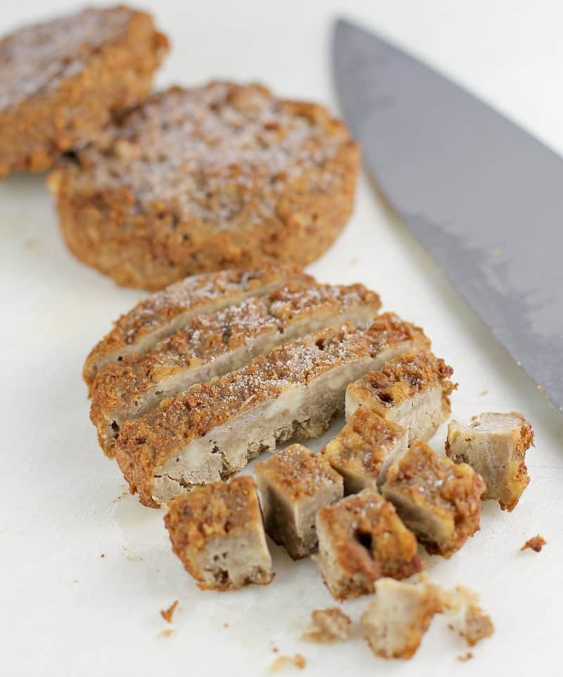 Morningstar sausage patties cut up on a cutting board