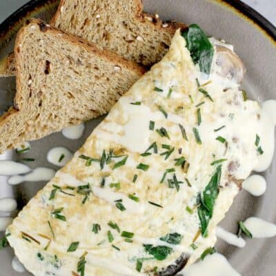 finished omelet on a plate with toast, top view