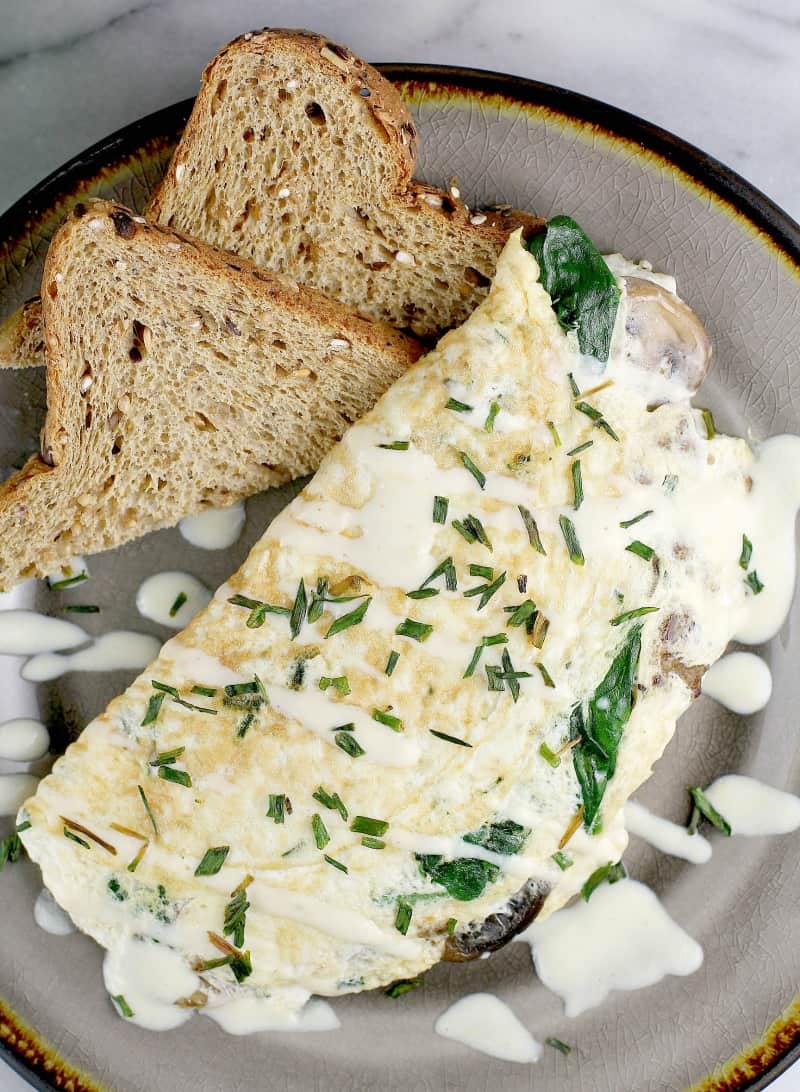 finished omelet on a plate with toast, top view