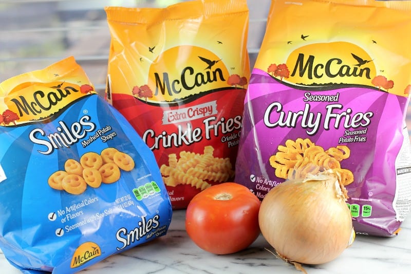 the three bags of McCain potato products; tomato and onion in the forefront