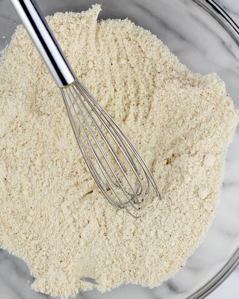 almond flour in a glass bowl with a whisk