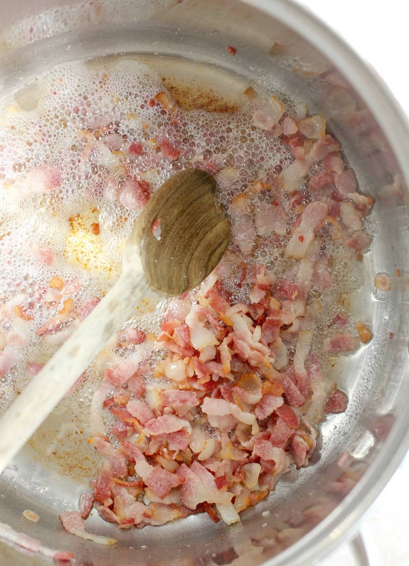 chopped bacon cooking in a pot