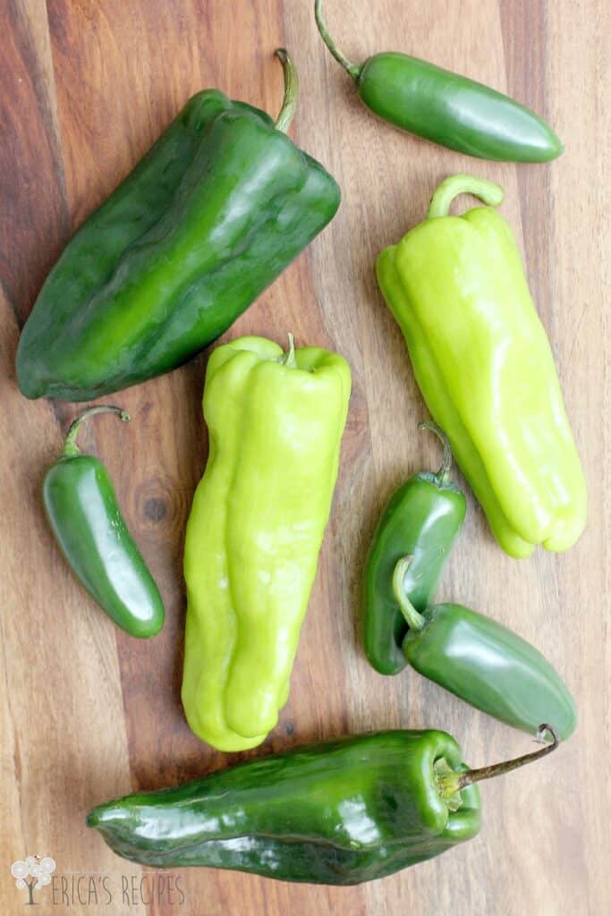 top down view of the whole peppers before cooking on a wood cutting board