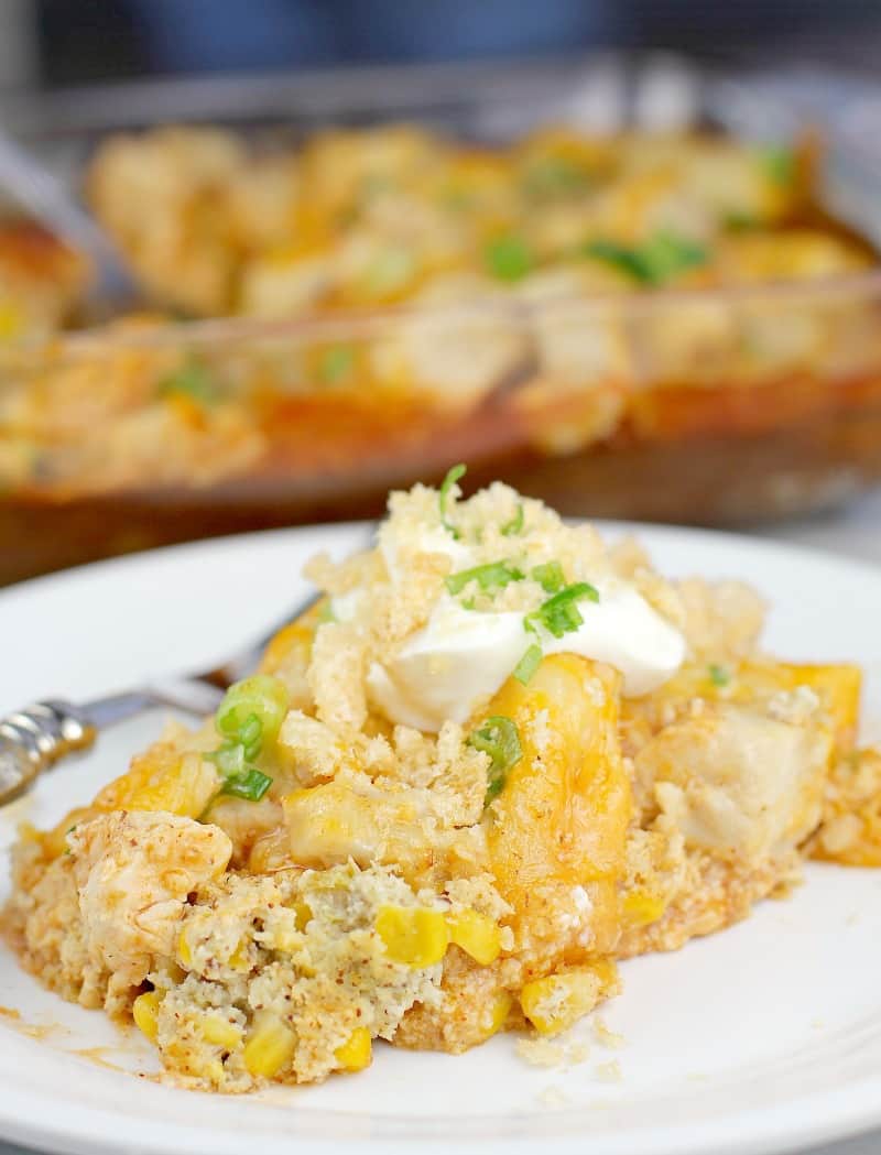 Finished casserole plated on a white plate; bake dish is in the background