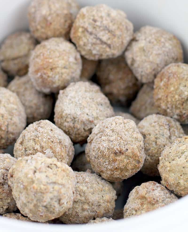 frosty frozen meatballs in a white ceramic crockpot