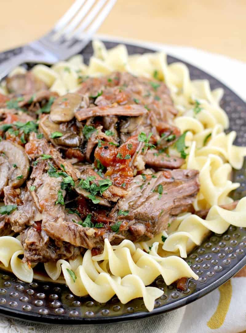 side view from the right, plated instant pot beef over noodles