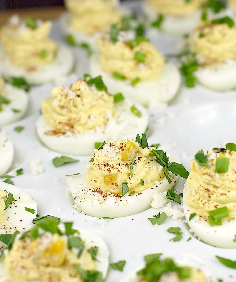 Mexican deviled eggs on a white serving platter