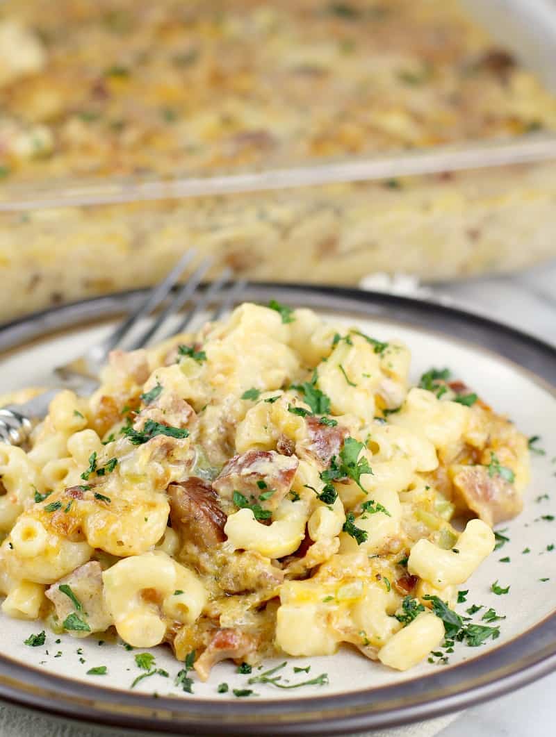 plated mac and cheese with the casserole dish in the background