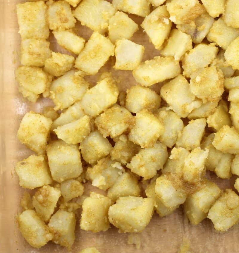 uncooked potatoes coated in seasoning before cooking