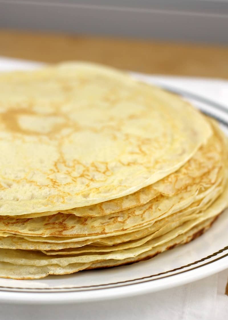 stack of thin crepes on a white plate