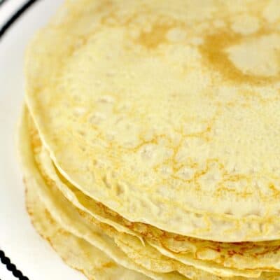 round crepes piled on white plate