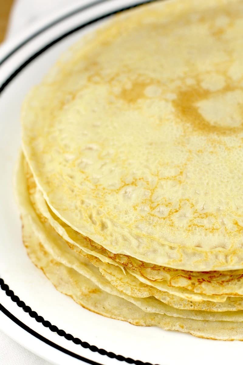 round crepes piled on white plate