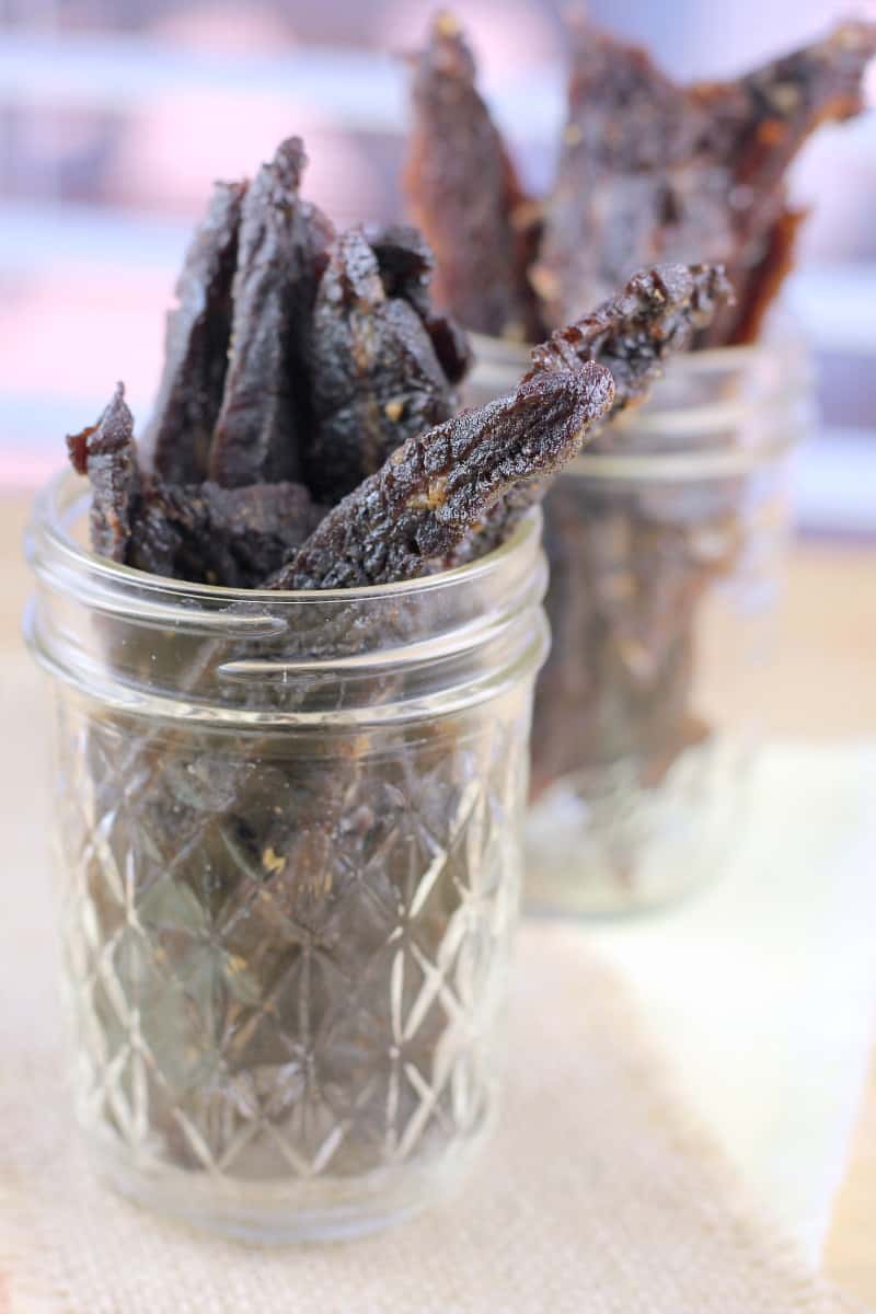 side view of terijaki beef jerky in glass jar