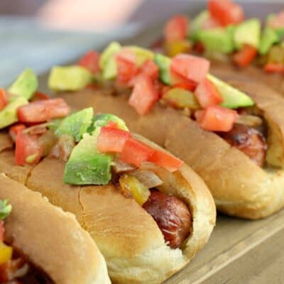 4 hot dogs in buns topped with sweet pepper relish