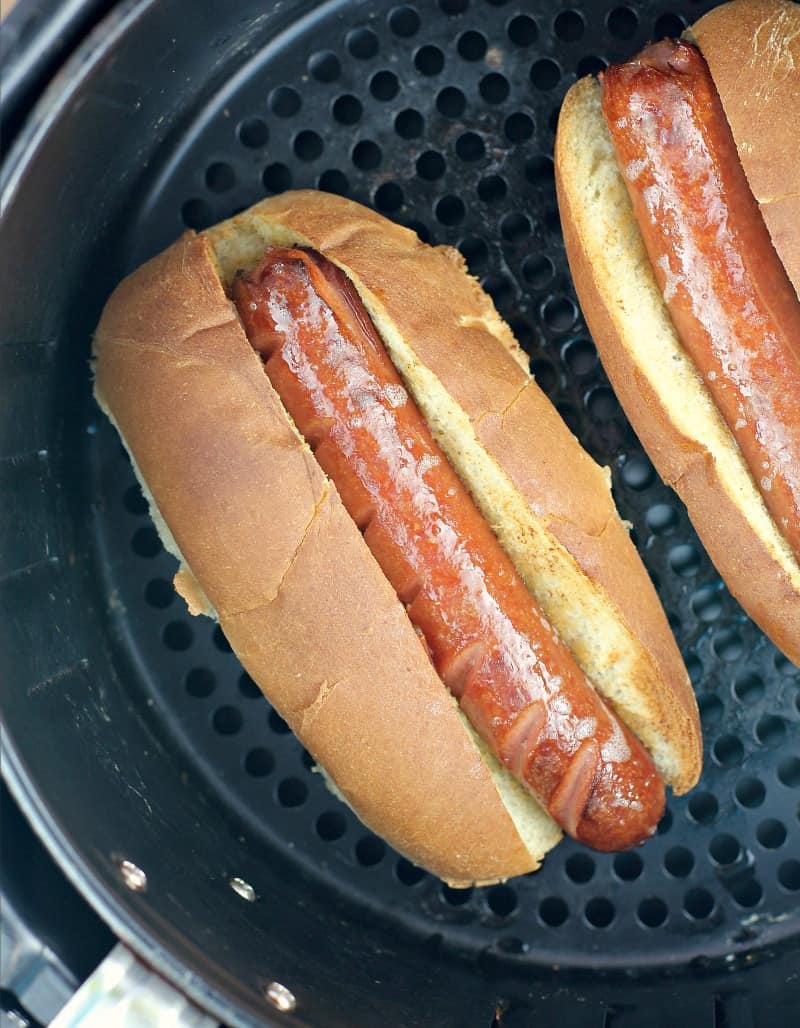 hot dog in a bun in an air fryer basket