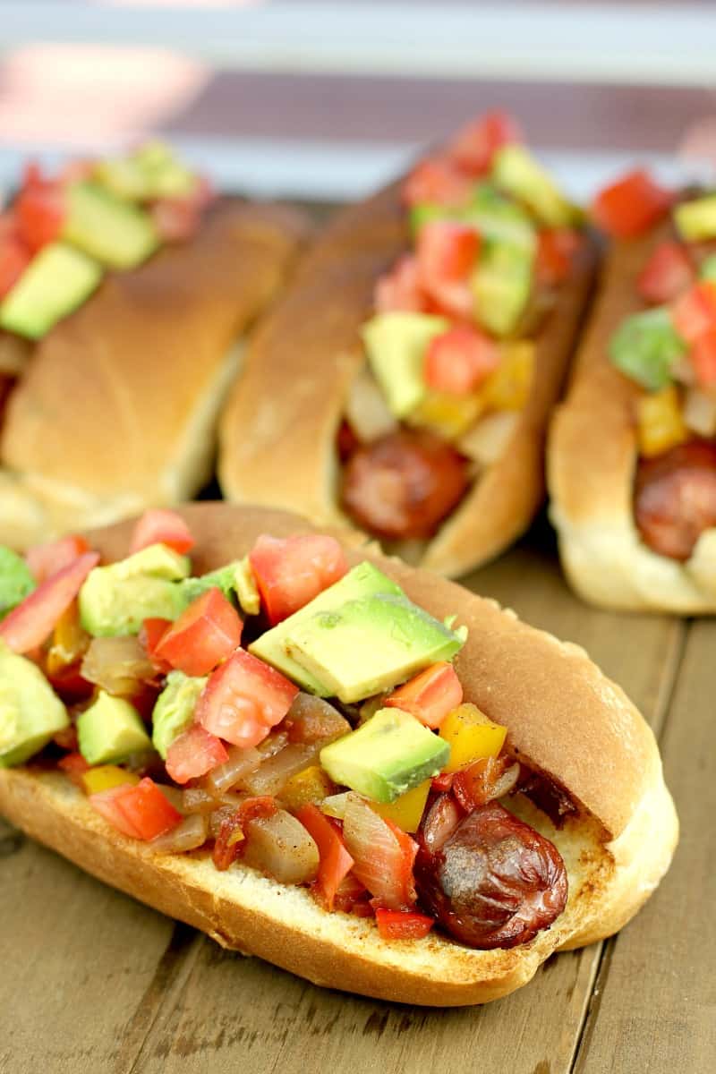 hot dog topped with Jamaican relish on a wood board