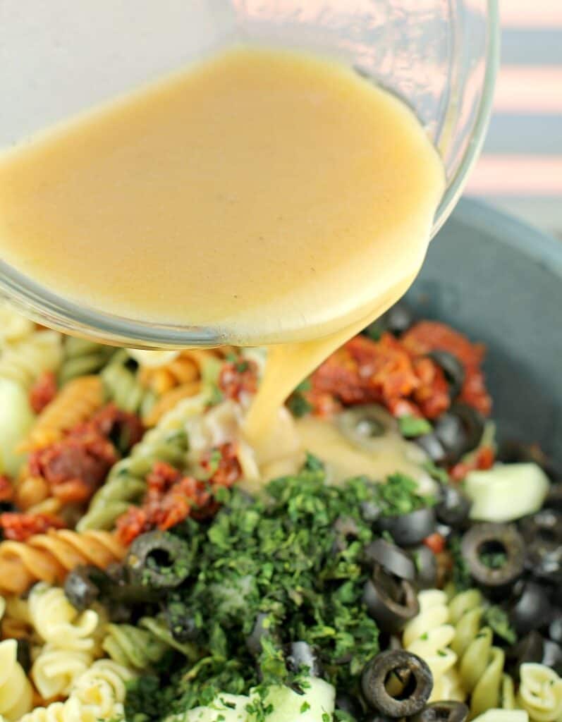 vinaigrette pouring into salad