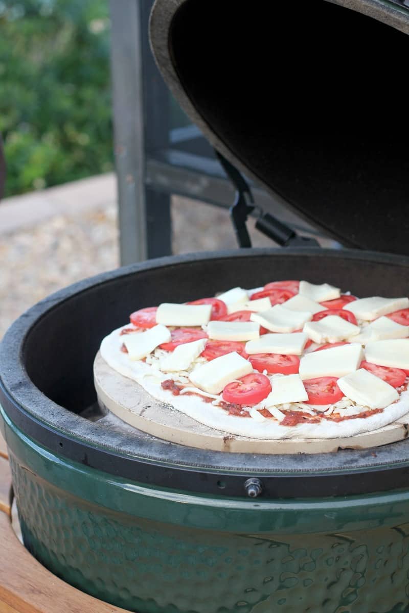 pizza cooking on the grill