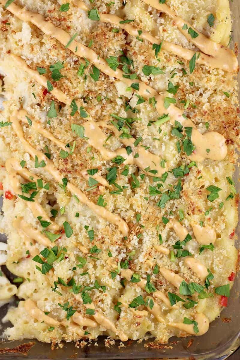 finished casserole in pyrex bake dish topped with remoulade and parsley
