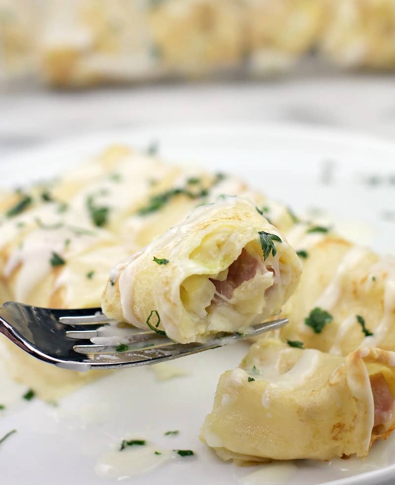 fork holding a bite of breakfast crepe