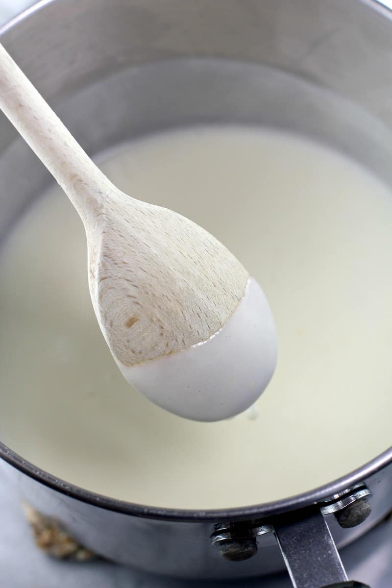 back of wooden spoon with bechamel sauce