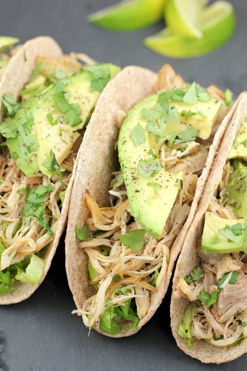 three tacos with chicken and avocado