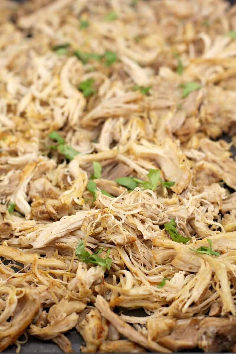 finished chicken topped with cilantro spread on a bake sheet