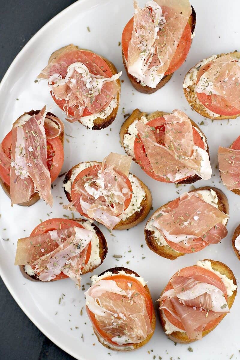 numerous crostini on a white plate