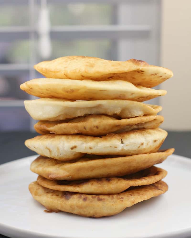 fried tortillas stack on a white plate