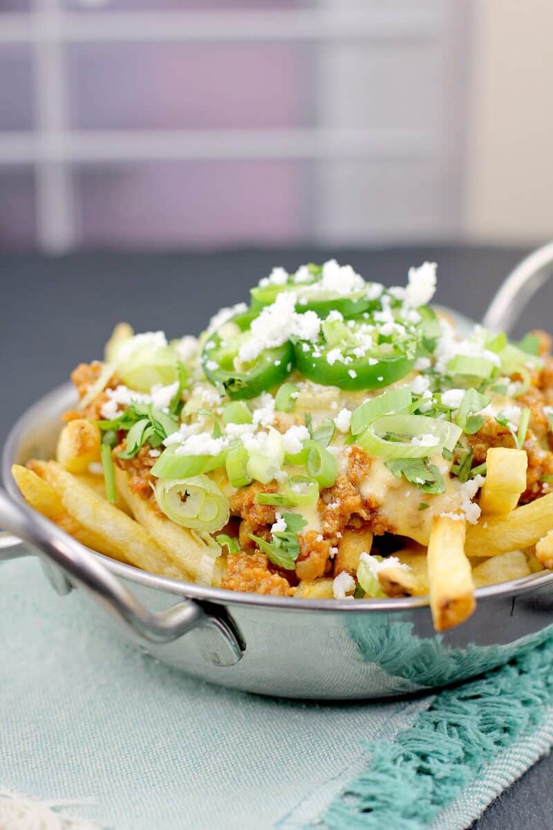 side view poutine in a metal dish